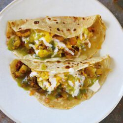 breakfast tacos with potato, eggs, chorizo, cheese & hatch green chile.