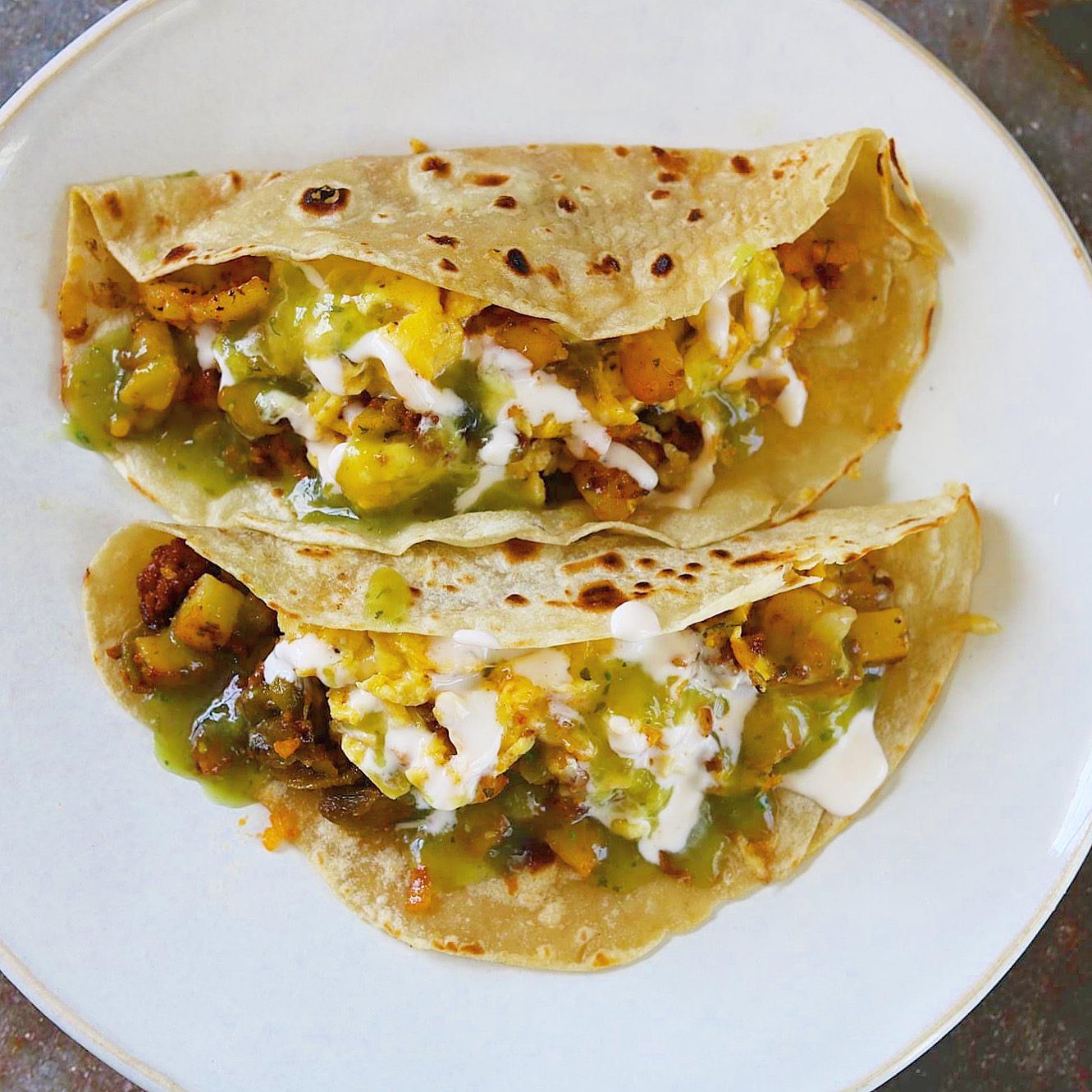 breakfast tacos with potato, eggs, chorizo, cheese & hatch green chile.