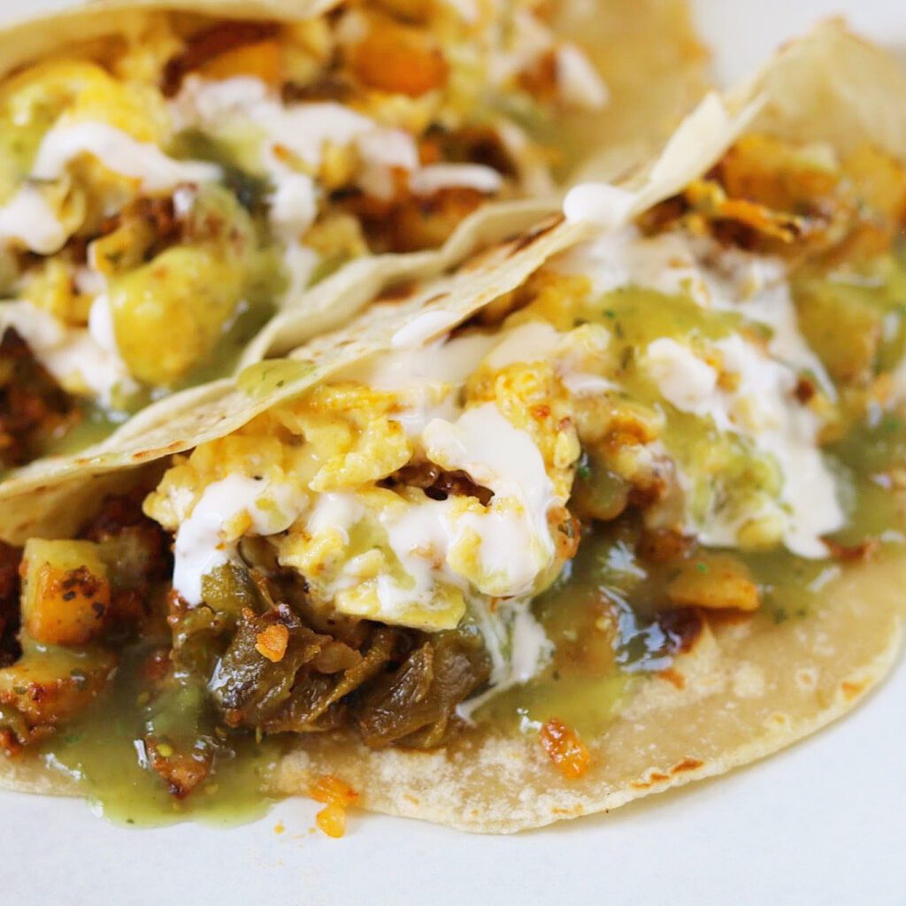 breakfast tacos with potato, eggs, chorizo, cheese & hatch green chile.