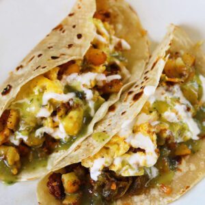 breakfast tacos with potato, eggs, chorizo, cheese & hatch green chile.